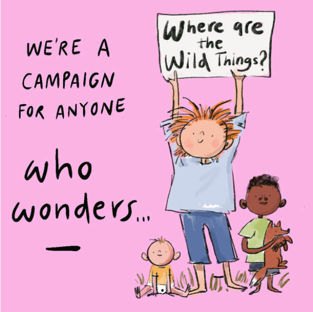 A group of people, including a child and a baby holding a placard WHERE ARE THE WILD THINGS?